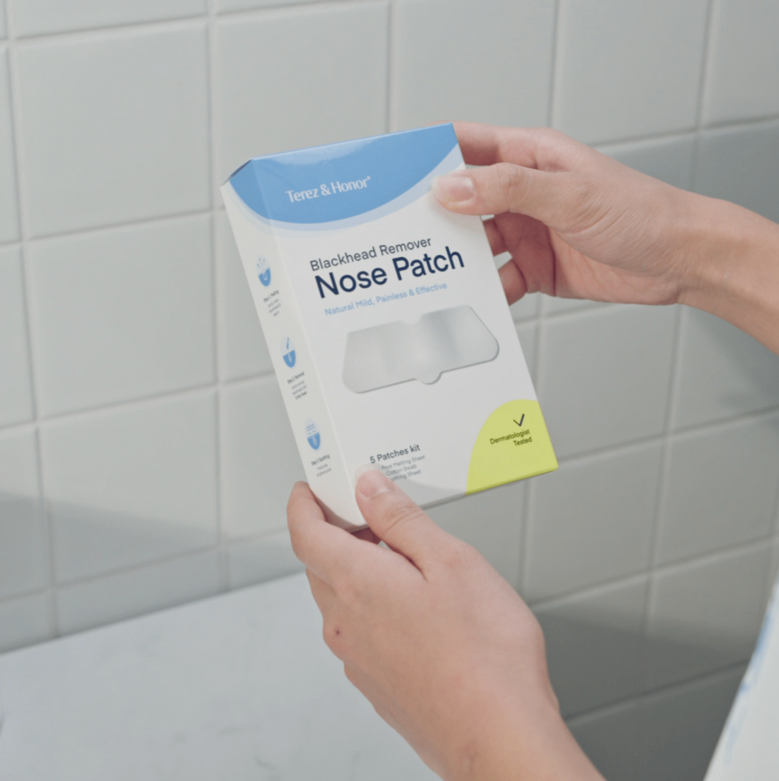 man holding the package of terez & honor blackhead remover nose patch in the bathroom