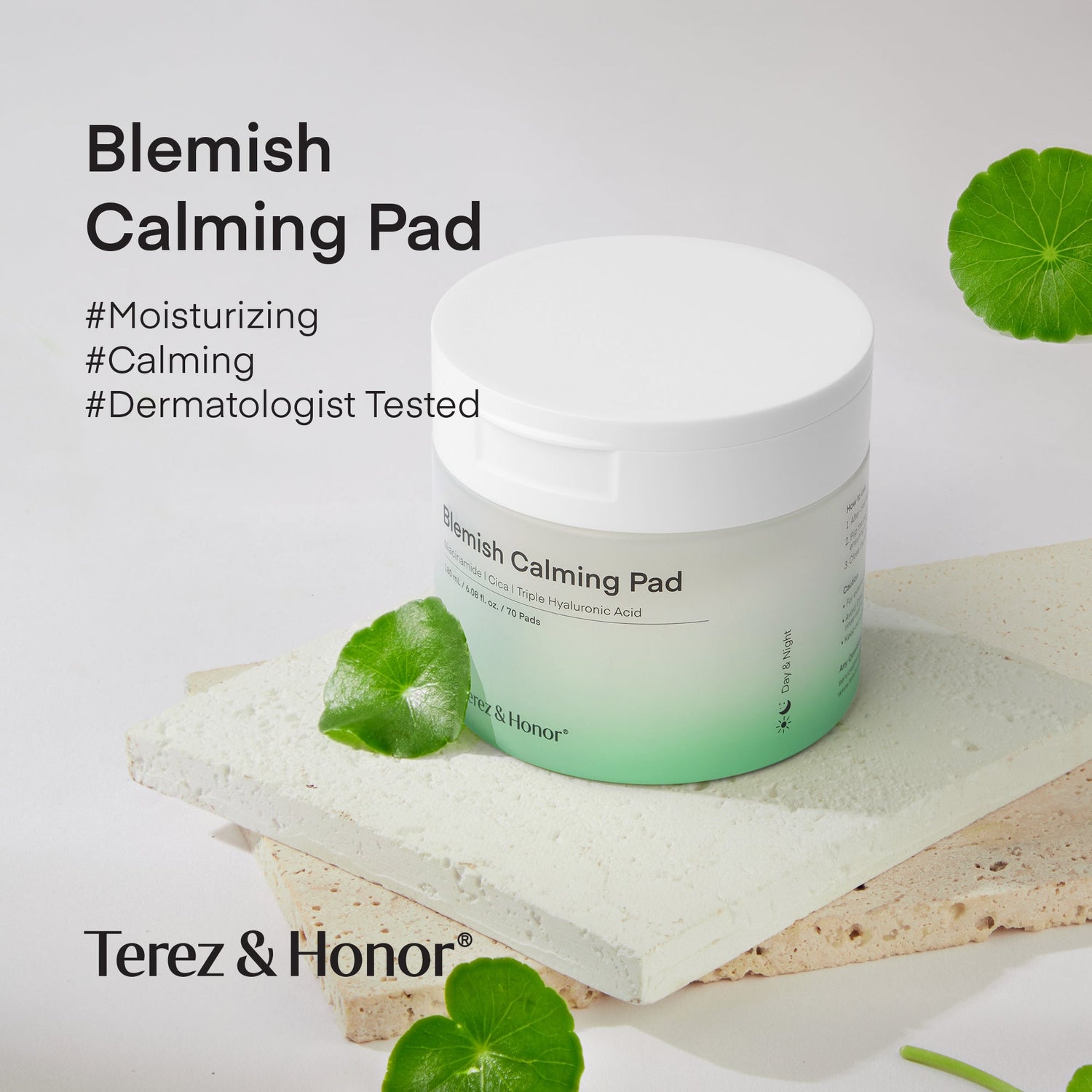 Jar of Terez &amp; Honor Blemish Calming Pads placed on a textured stone surface, surrounded by fresh green leaves, highlighting the product&
