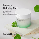 Jar of Terez & Honor Blemish Calming Pads placed on a textured stone surface, surrounded by fresh green leaves, highlighting the product&