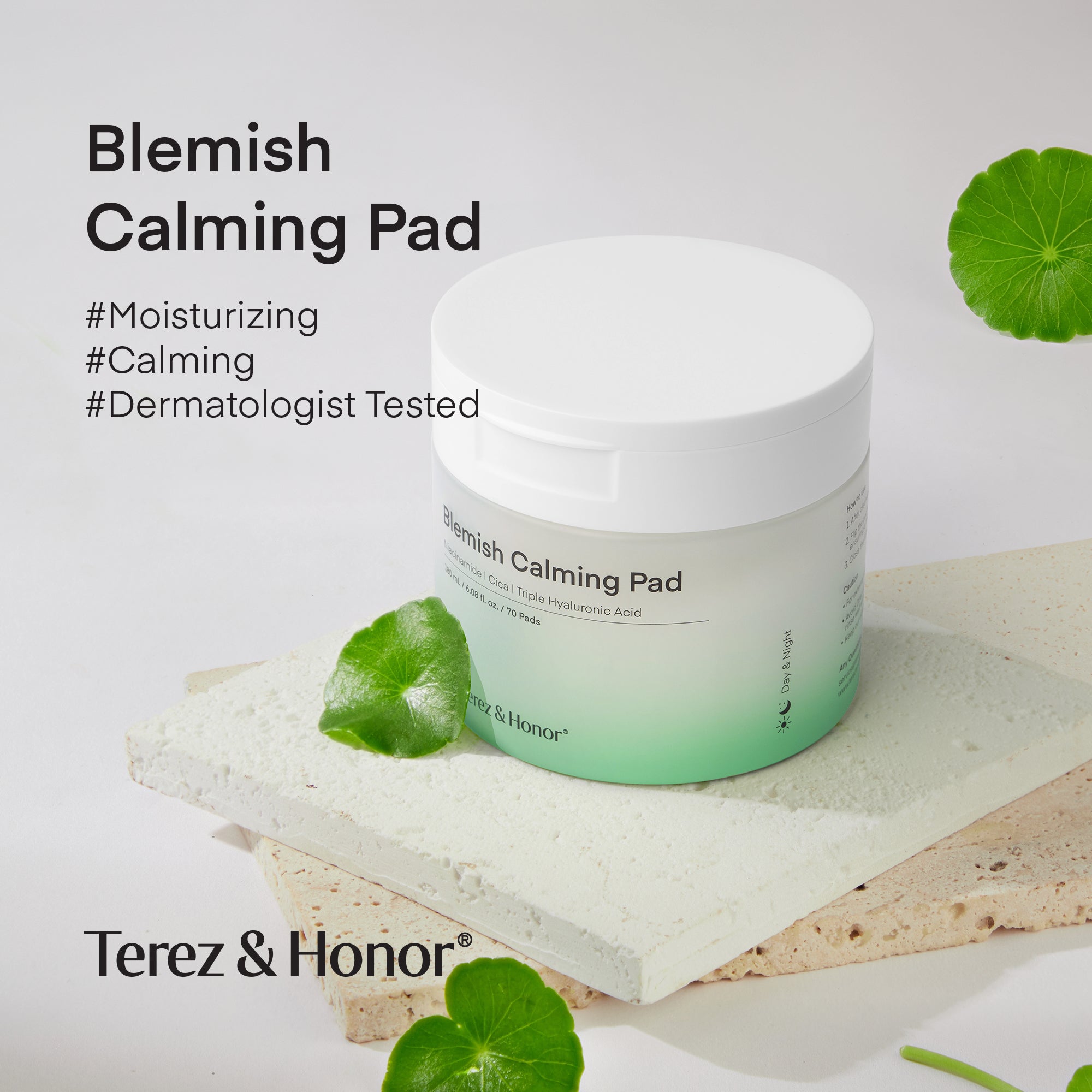 Jar of Terez &amp; Honor Blemish Calming Pads placed on a textured stone surface, surrounded by fresh green leaves, highlighting the product&
